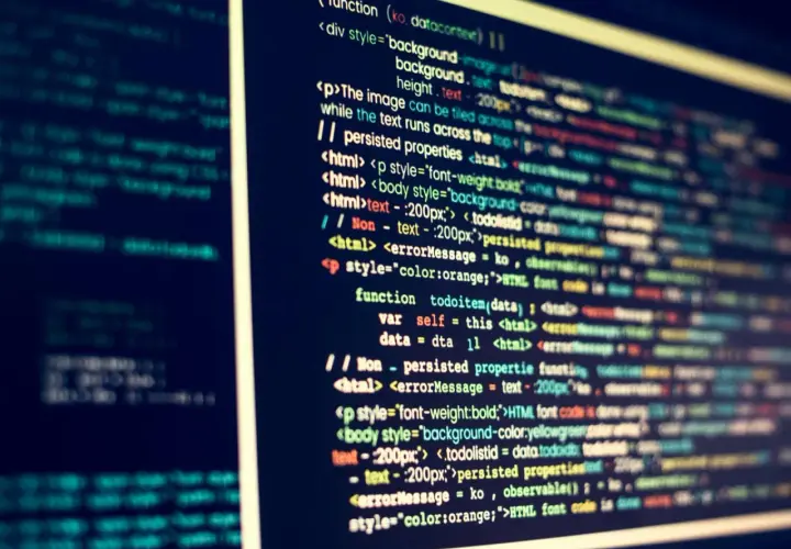 Nahaufnahme eines Computerbildschirms mit buntem Code, der eine Internet-Programmiersprache darstellt.